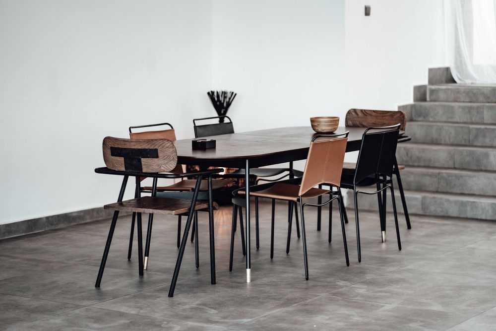 Illustrative dark wood dining table with chairs in a modern dining room