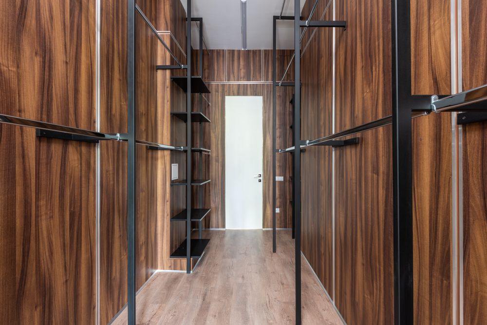 Illustrative open walnut-toned wardrobe with shelving and hanging rails